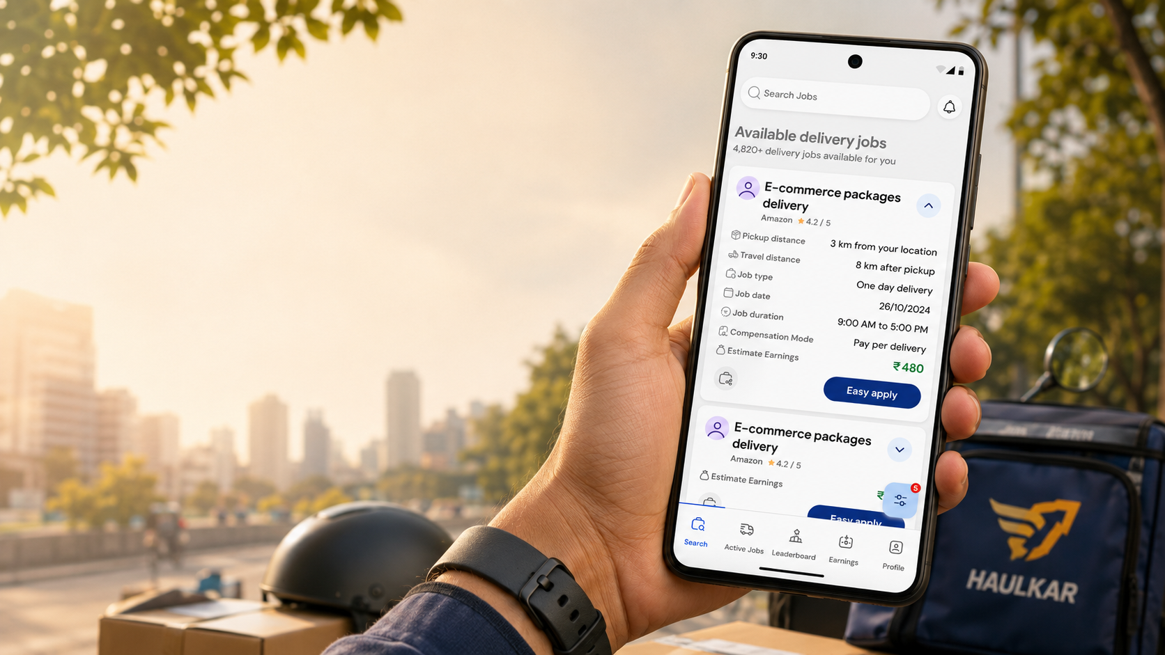 Haulkar gig logistics app screens, held in hand by a delivery rider